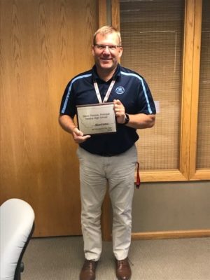 Photo of HHS Principal Steve Thennis holding plaque for his 2022 AA Principal of the Year Award