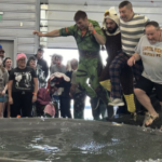 Photo of Principal Zanto and others jumping into tank of ice water at Sweetheart plunge fundraiser.